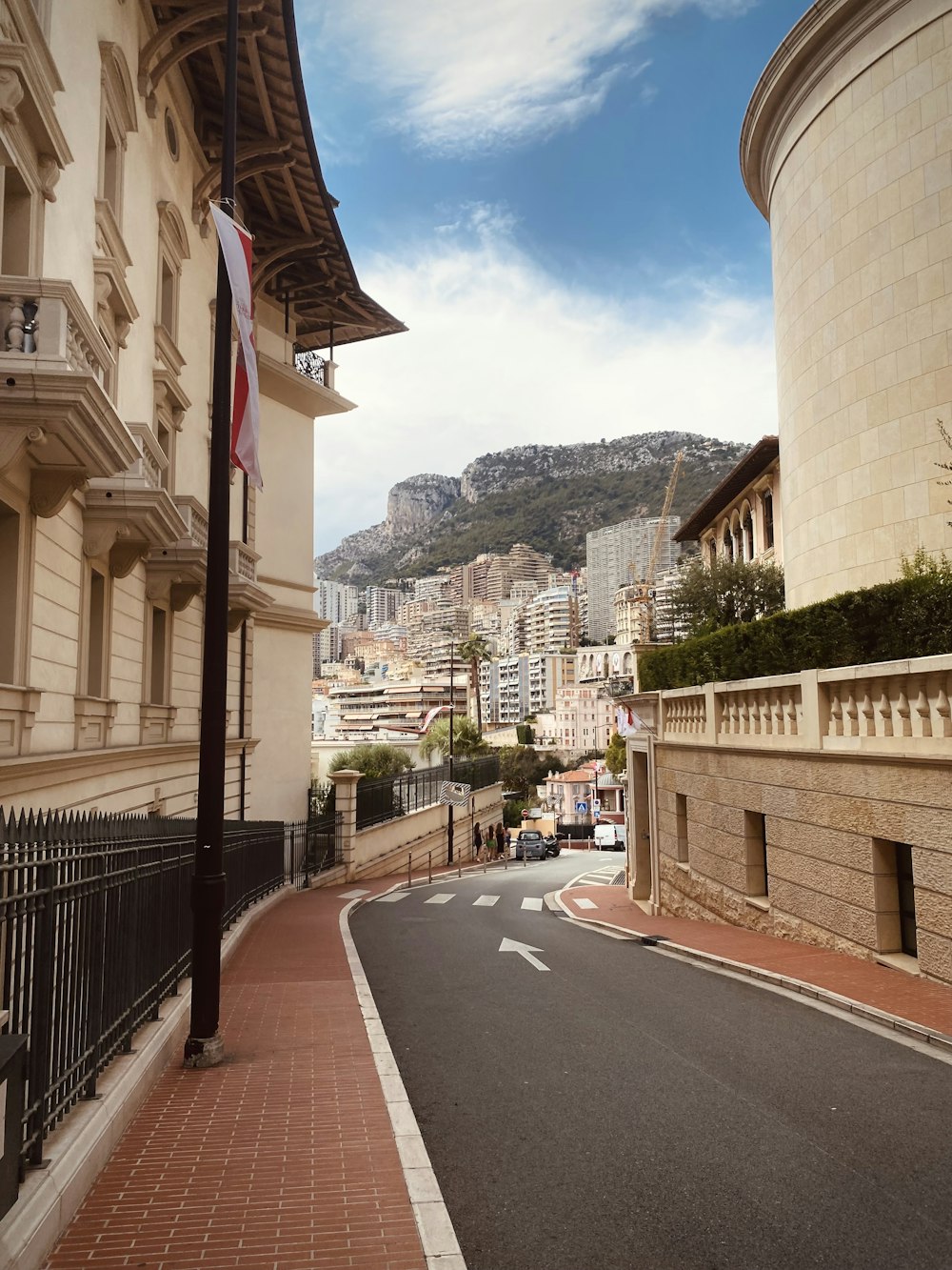 a street in a city with a mountain in the background