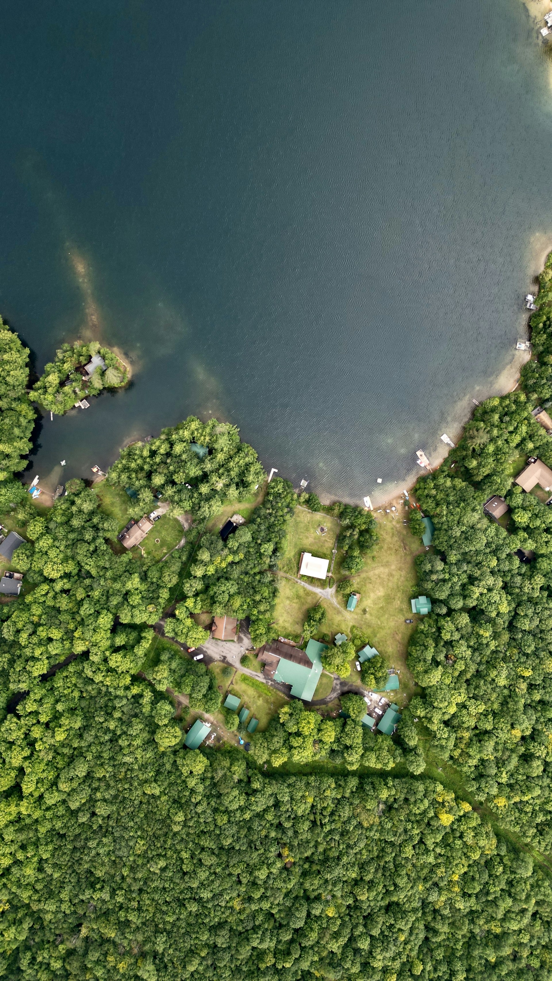an aerial view of a lake surrounded by trees