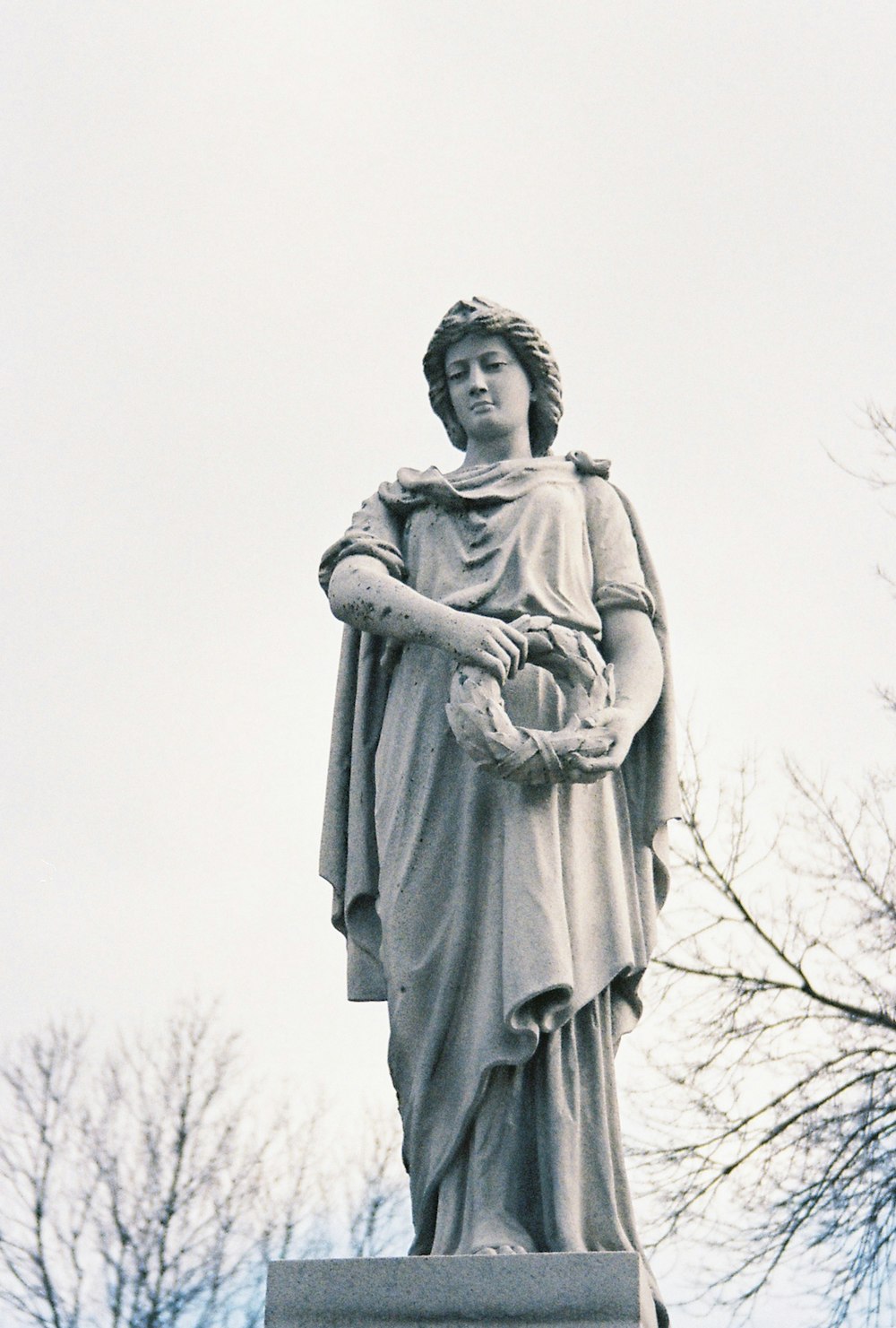 a statue of a woman holding a basket