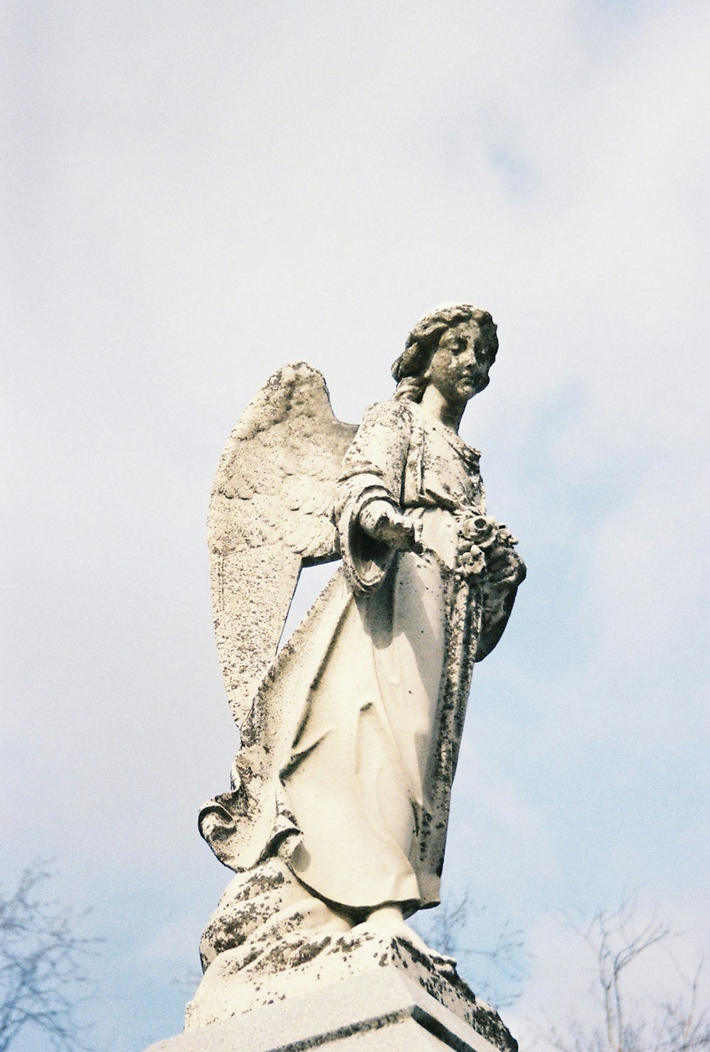 a statue of an angel on top of a building