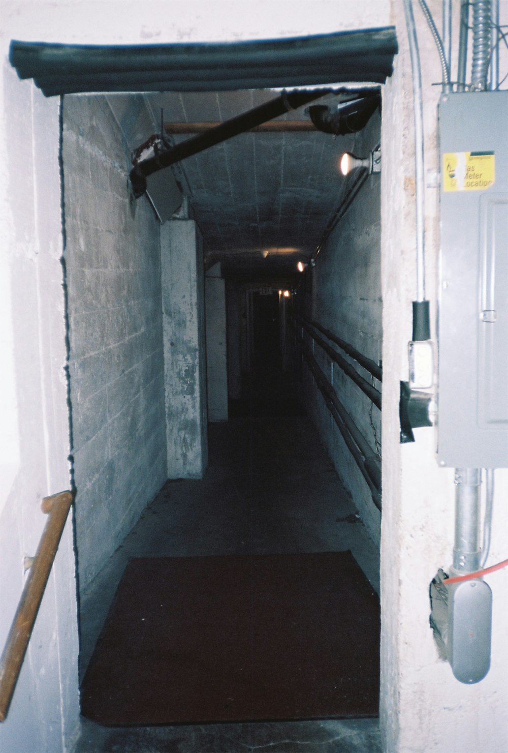 a long narrow hallway with a light on