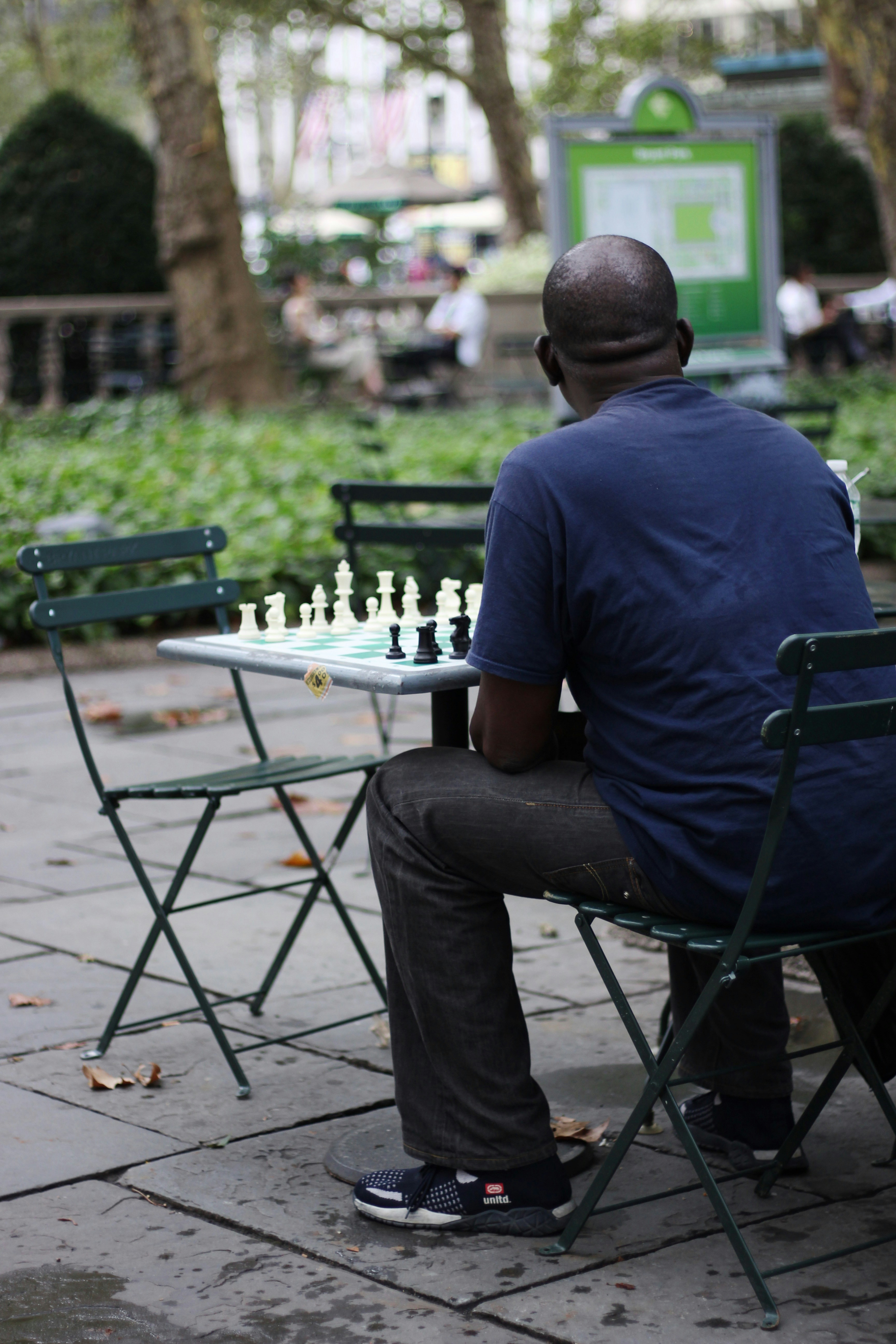 a man sitting at a table playing chess