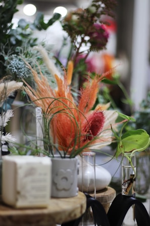 A collection of unique vases surrounded by delicate blooms.