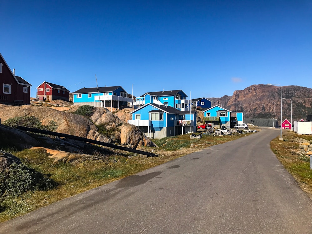 a street lined with houses next to a mountain