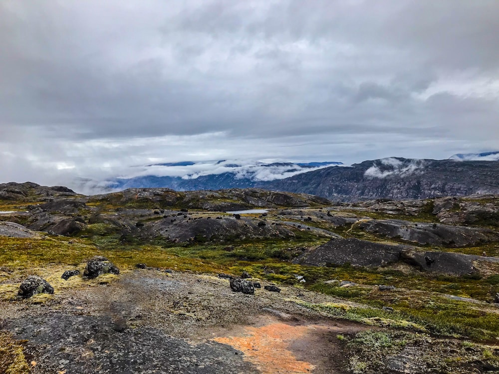 a view of the mountains from a rocky outcropping