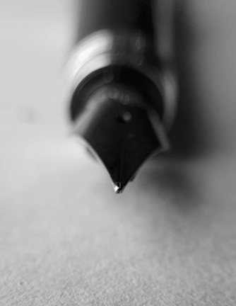 Artistic black and white photo highlighting the premium design details of the ink holder in use.
