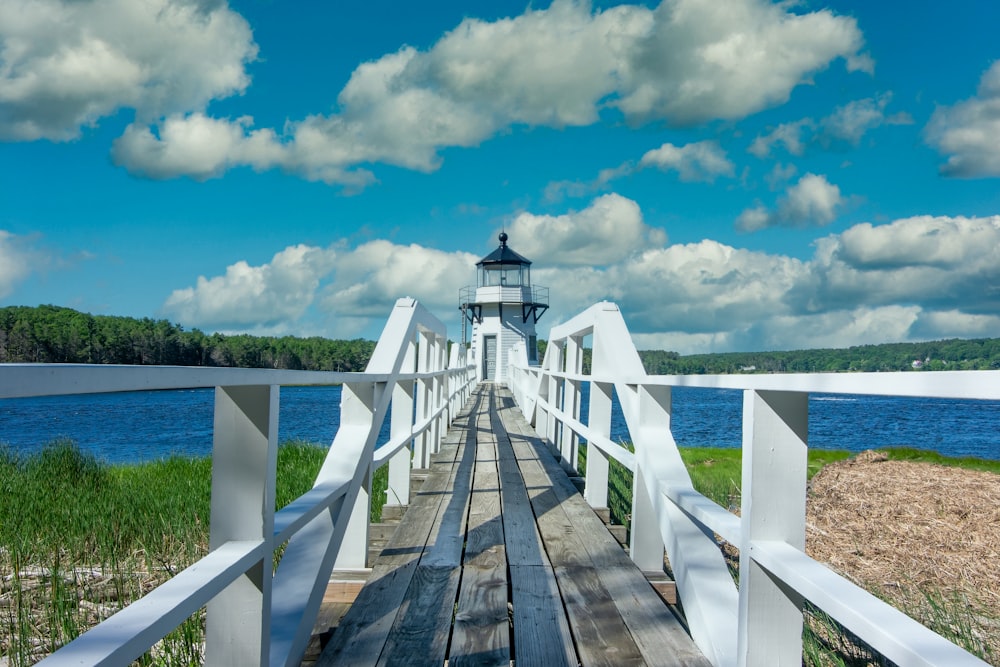 a wooden bridge with a light house on top of it