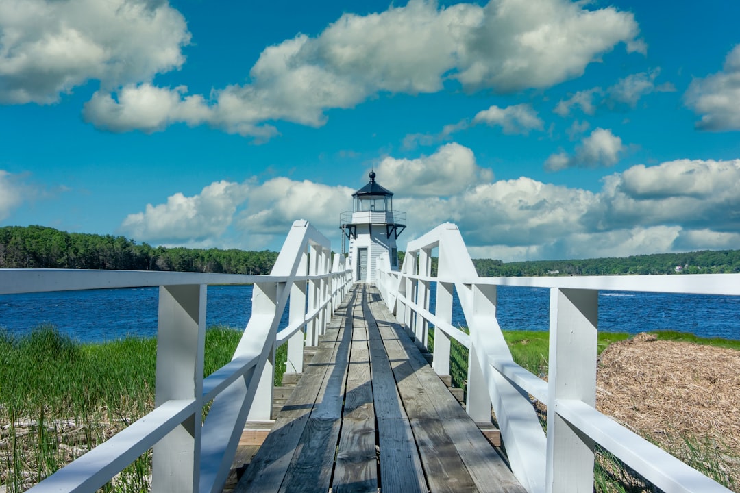 a wooden bridge with a light house on top of it, Doubling Point Lighthouse in Maine