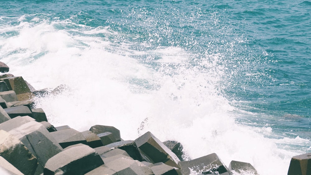 a man riding a surfboard on top of a wave in the ocean