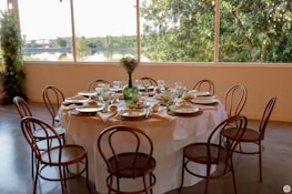 A beautiful dining table set arranged in a bright, airy room.