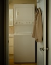 In-room washer and dryer unit tucked neatly in a compact closet.