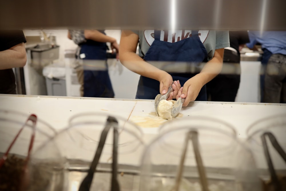 a person in a kitchen preparing food on a cutting board