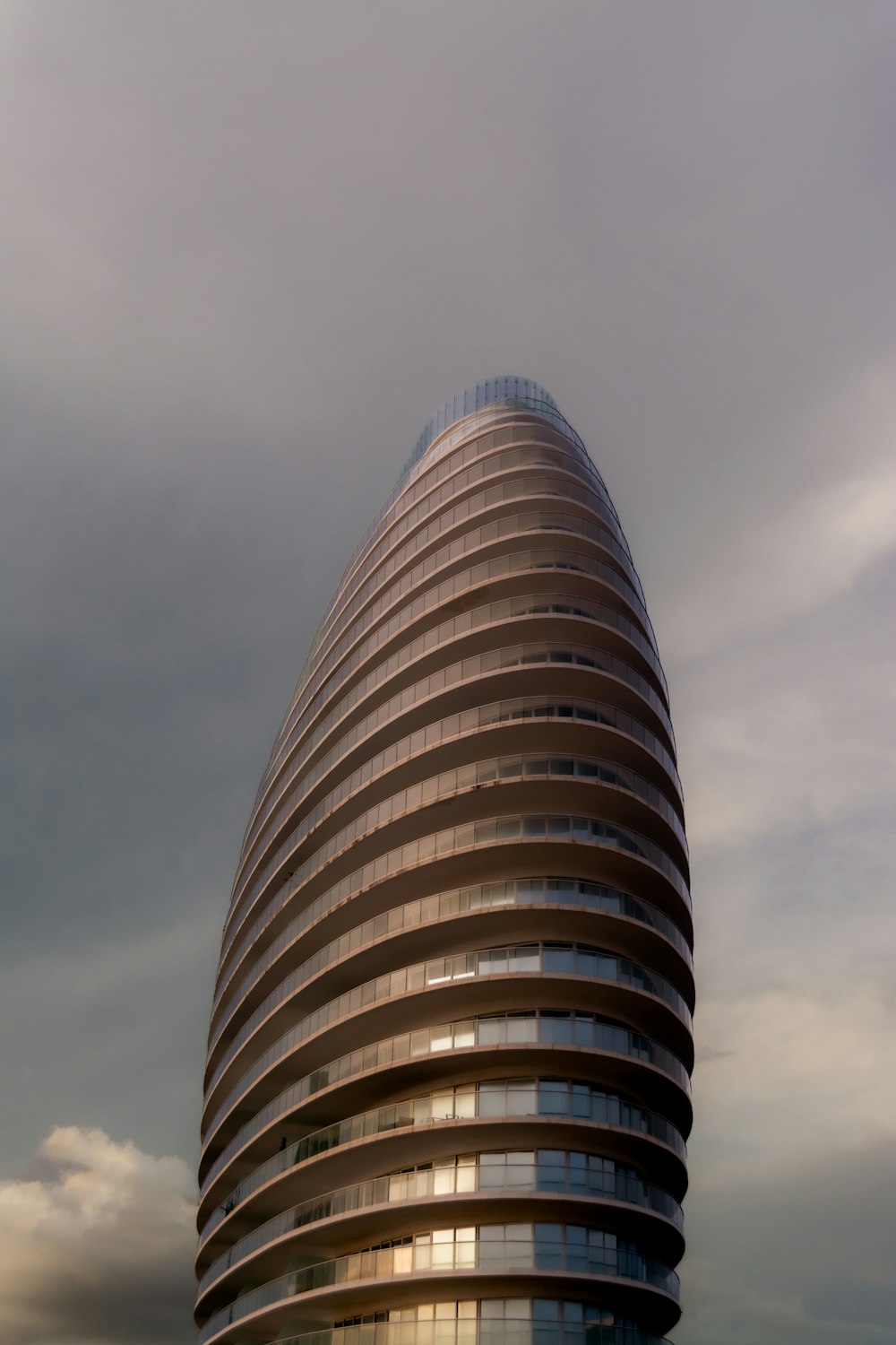 a very tall building sitting under a cloudy sky