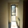 Cozy hallway featuring a narrow vintage printed runner rug with warm lighting.