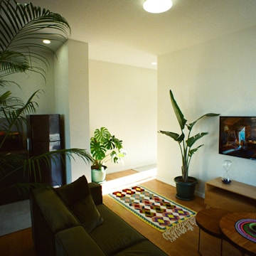 Modern living room with natural wood and green plants.