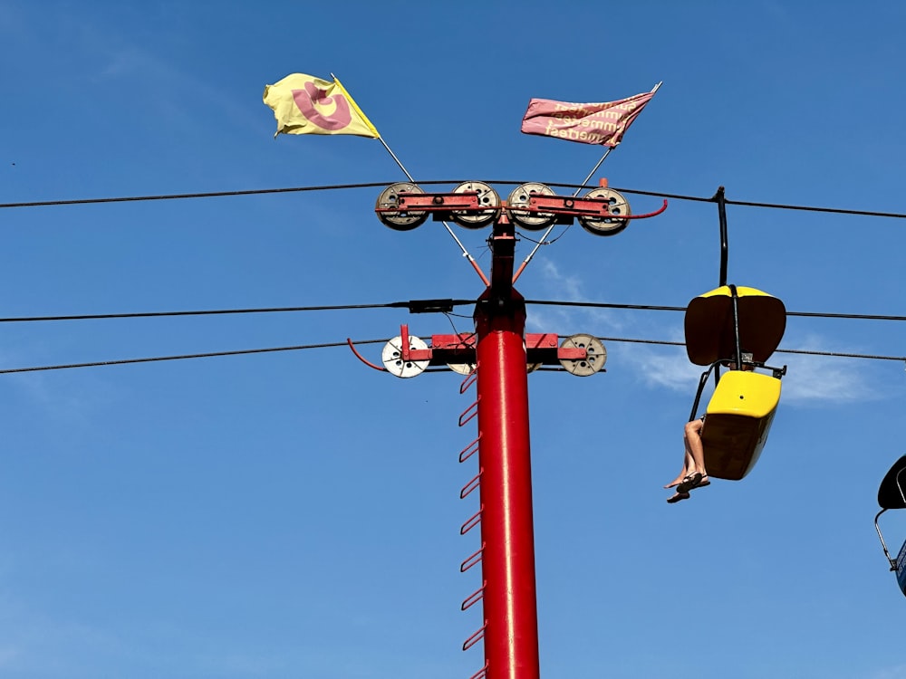 a red pole that has a bunch of wires attached to it