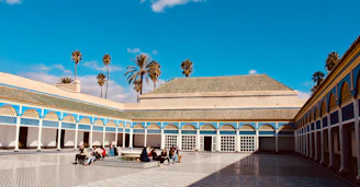 A warm, inviting community gathering in a sunny Mexican courtyard.
