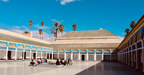 A warm, inviting community gathering in a sunny Mexican courtyard.