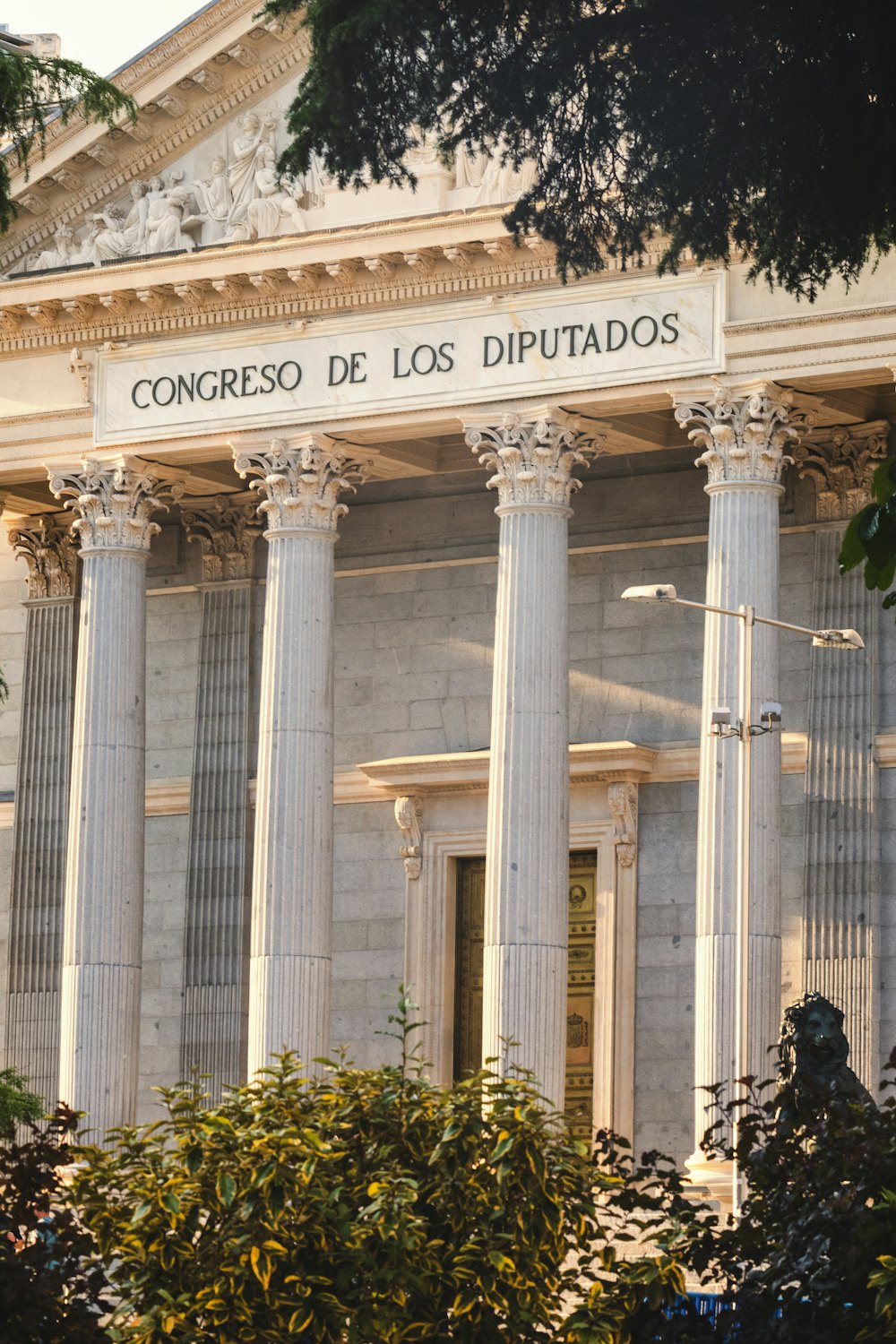 the front of a building with columns and a clock