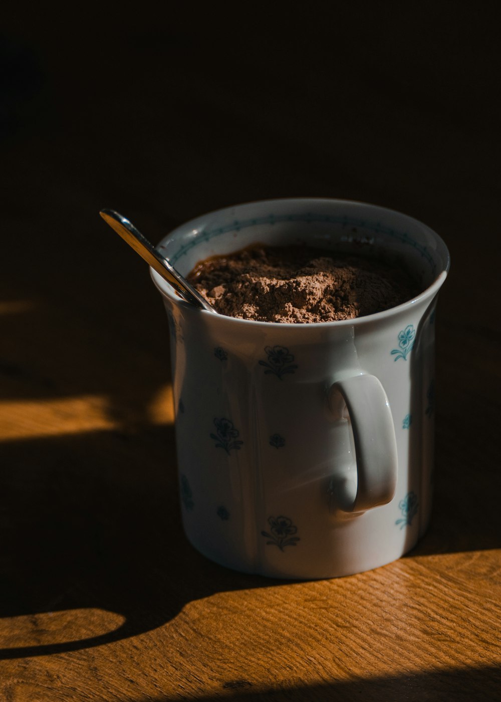 a cup of hot chocolate with a spoon in it