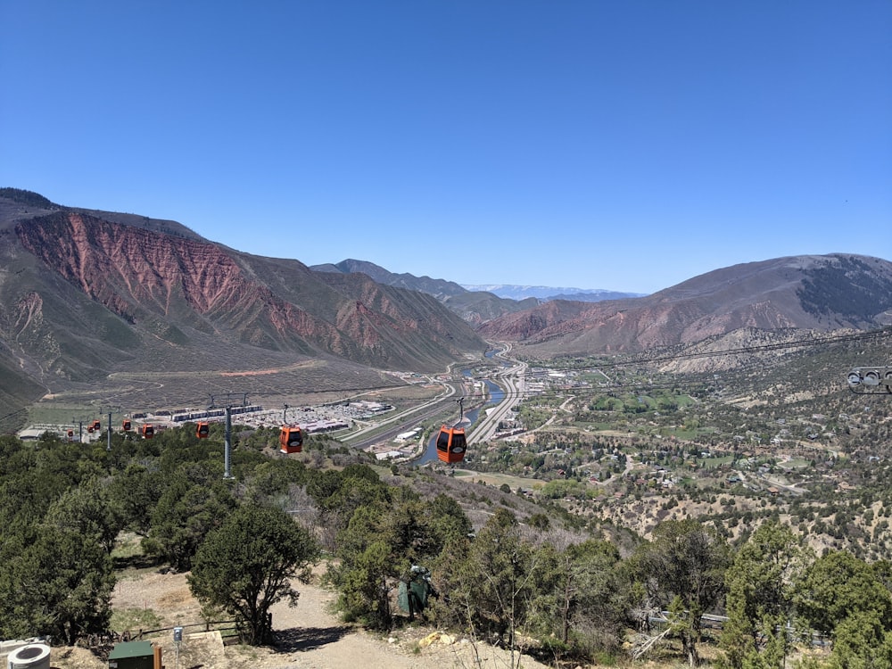 a scenic view of a valley with mountains in the background