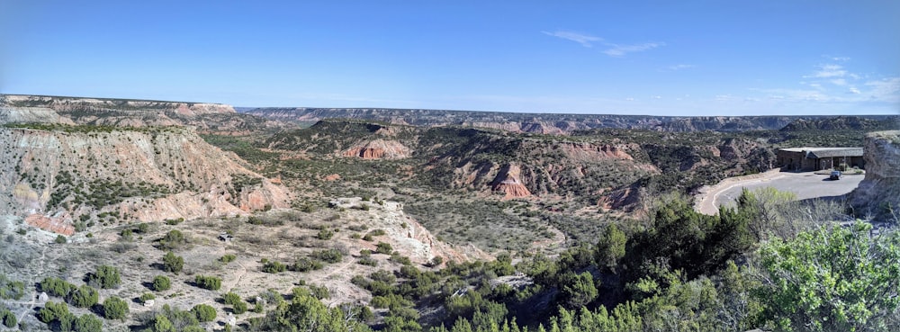 a scenic view of a canyon with a road going through it