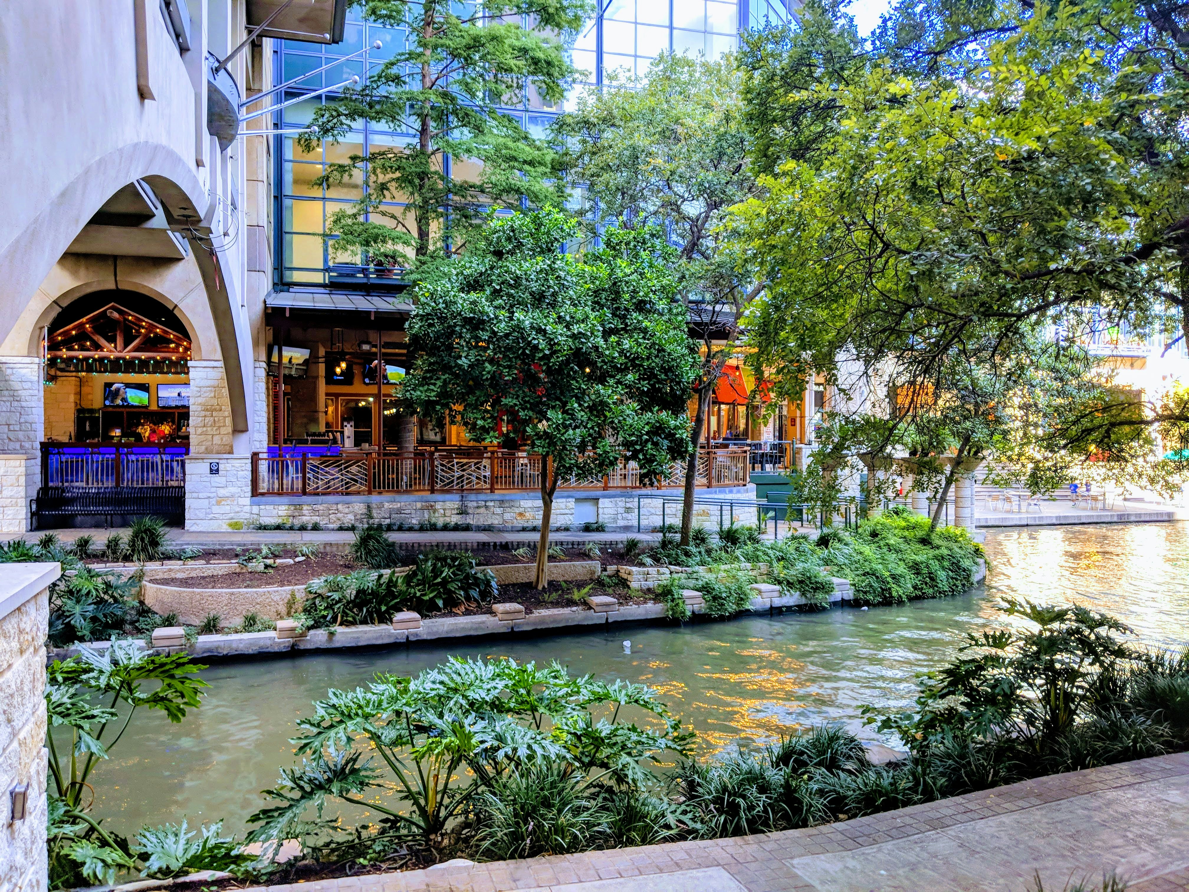 a river running through a city next to a tall building