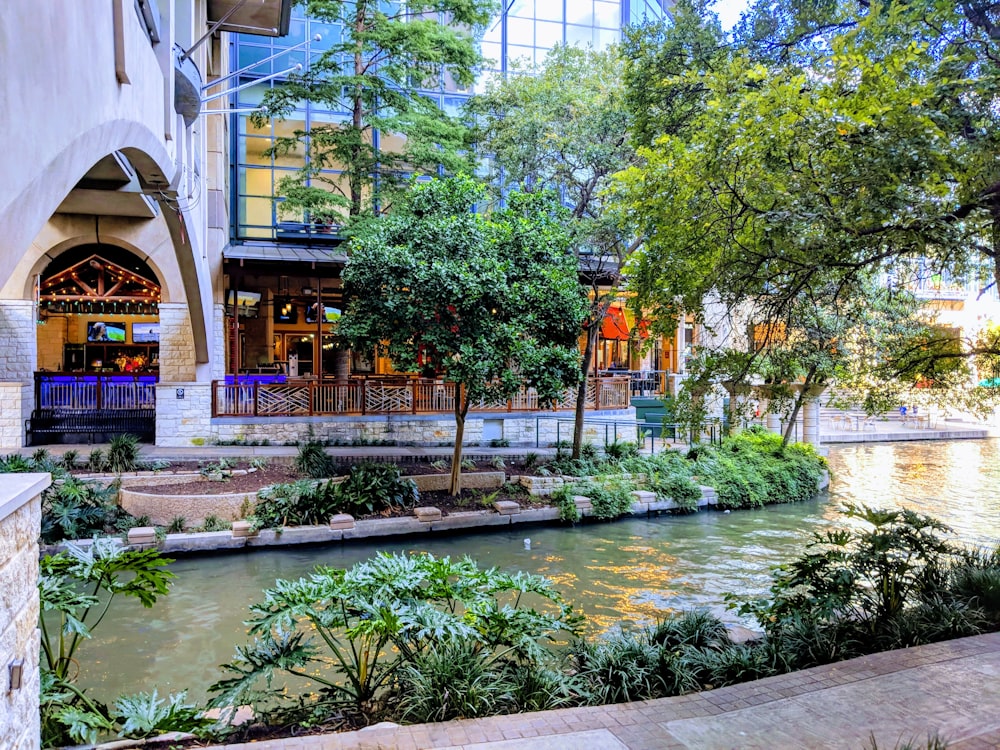 a river running through a city next to a tall building