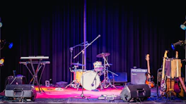 A vibrant stage setup with instruments ready for a live music session.