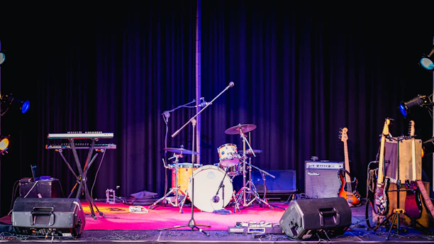 A vibrant stage setup with musical instruments ready for a Polish music setlist performance.