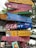 A colorful wooden signpost with various arrows pointing in different directions, each painted with text and designs. The signs include phrases like 'No Pokemon,' 'Go to Hawaii,' 'USA-NY Area 51,' references to specific countries like Burkina Faso and France, and illustrations from pop culture.