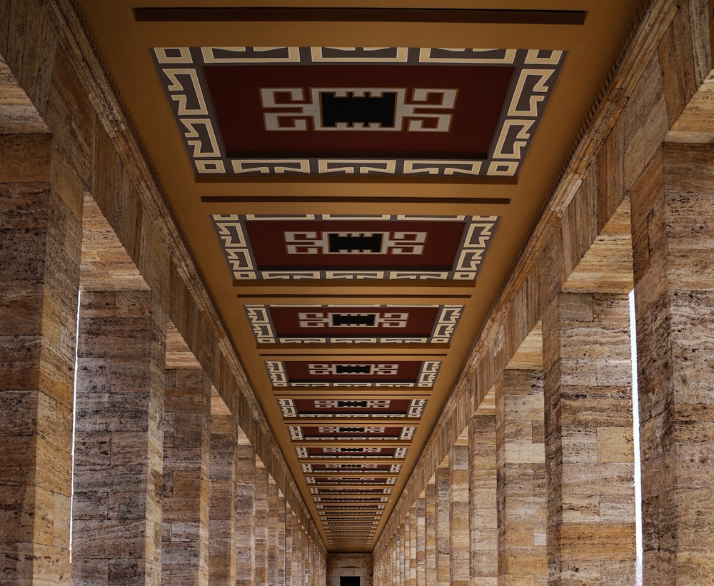 a long hallway in a building with columns