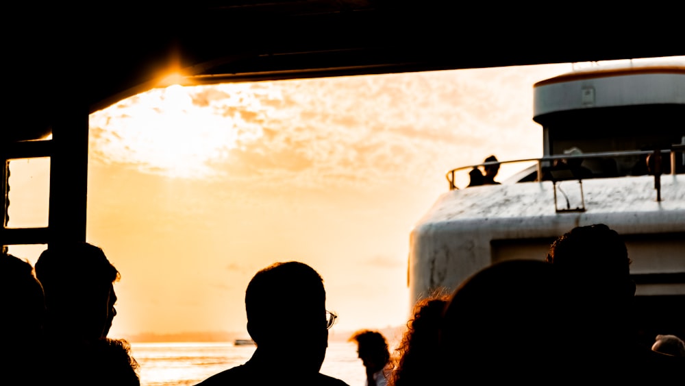 a group of people standing next to a boat