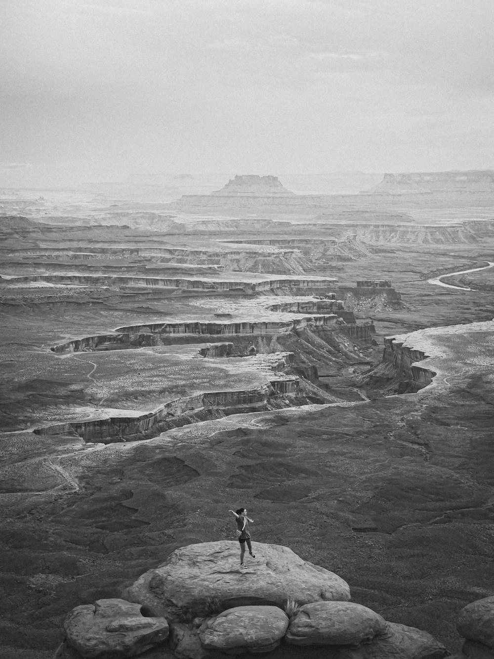 a person standing on top of a large rock