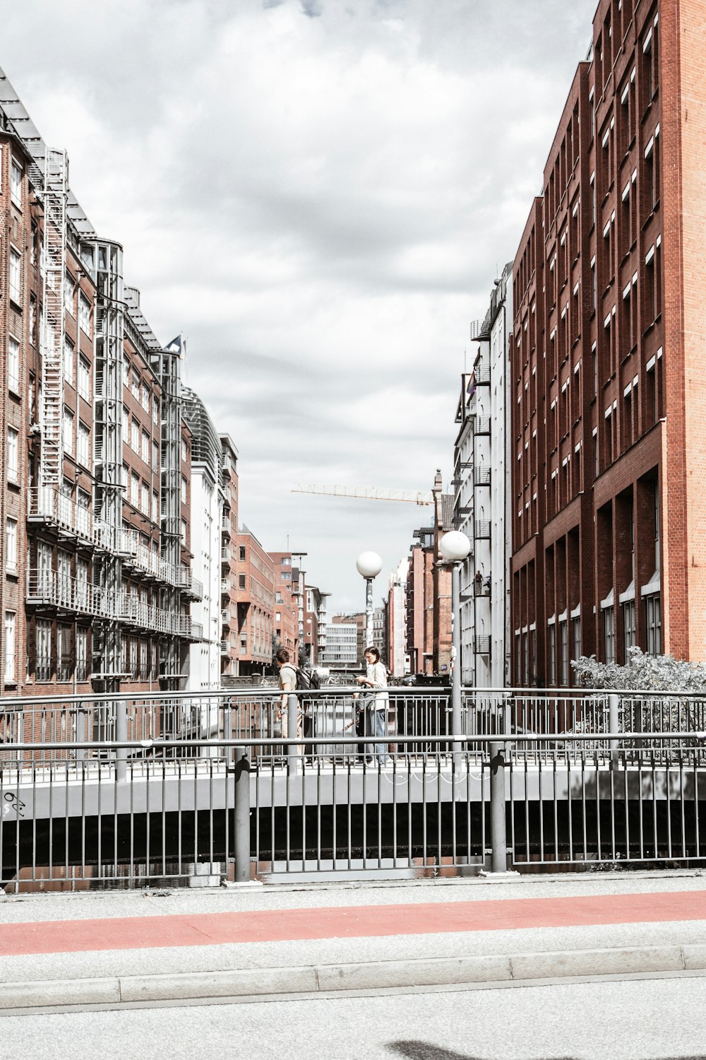 a man riding a skateboard down a street next to tall buildings