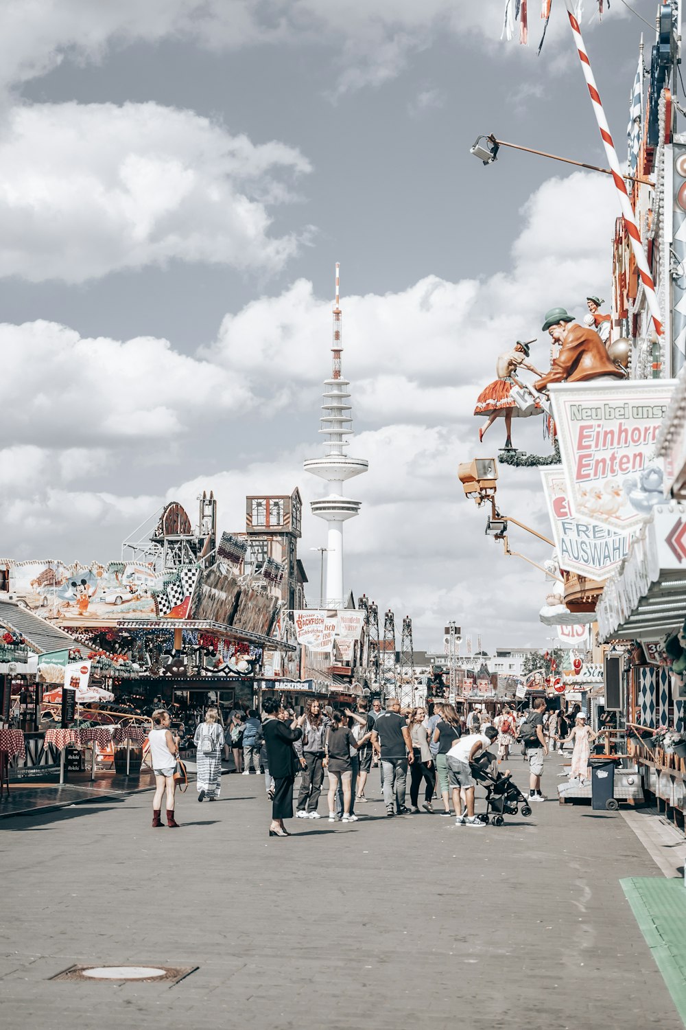 a crowd of people walking around a carnival