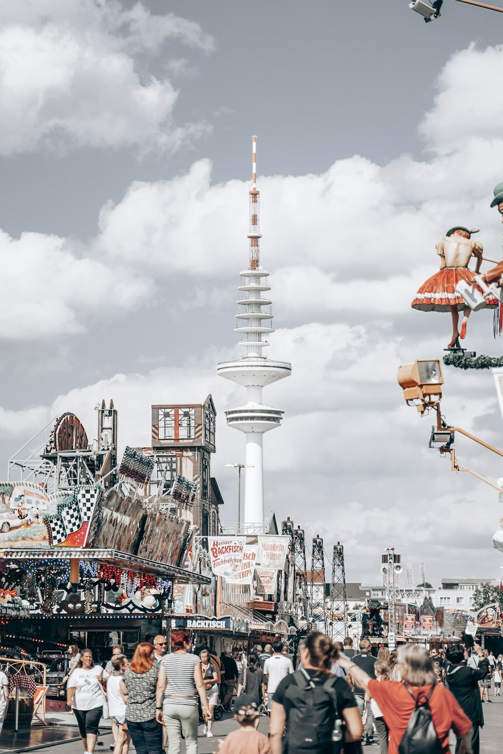 a crowd of people walking around a carnival