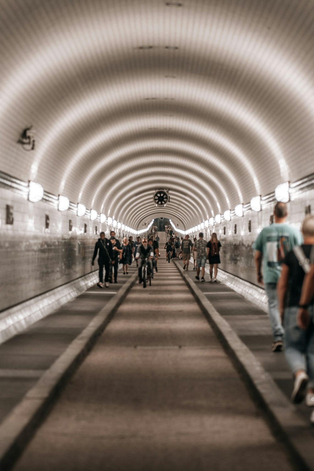 a group of people walking through a tunnel