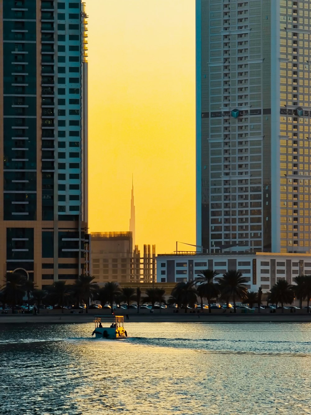 a boat is in the water in front of some tall buildings