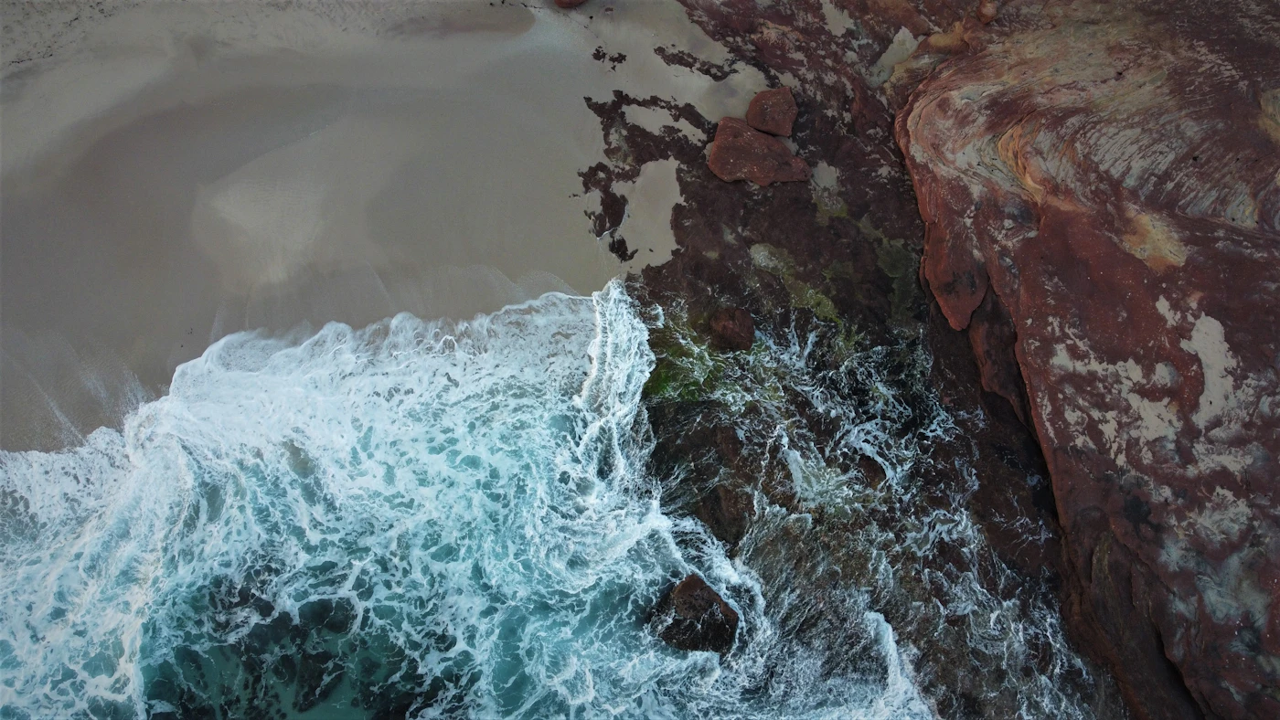 Aerial view of surf breaking over rocks along the Kalbarri coastline