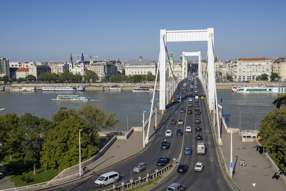 a view of a bridge over a river with cars driving on it