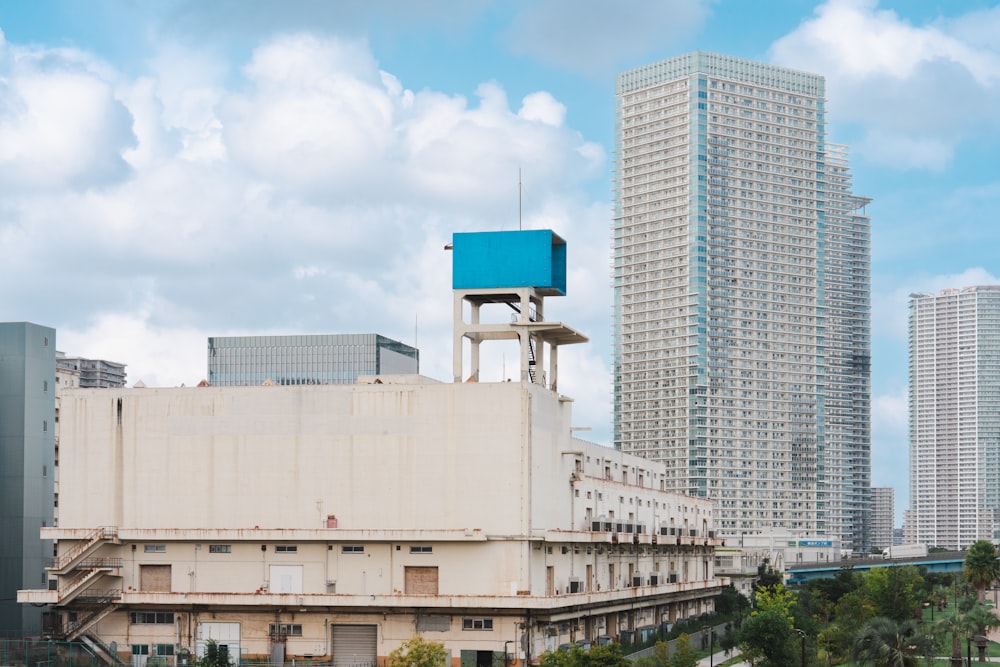 a tall building with a blue sign on top of it