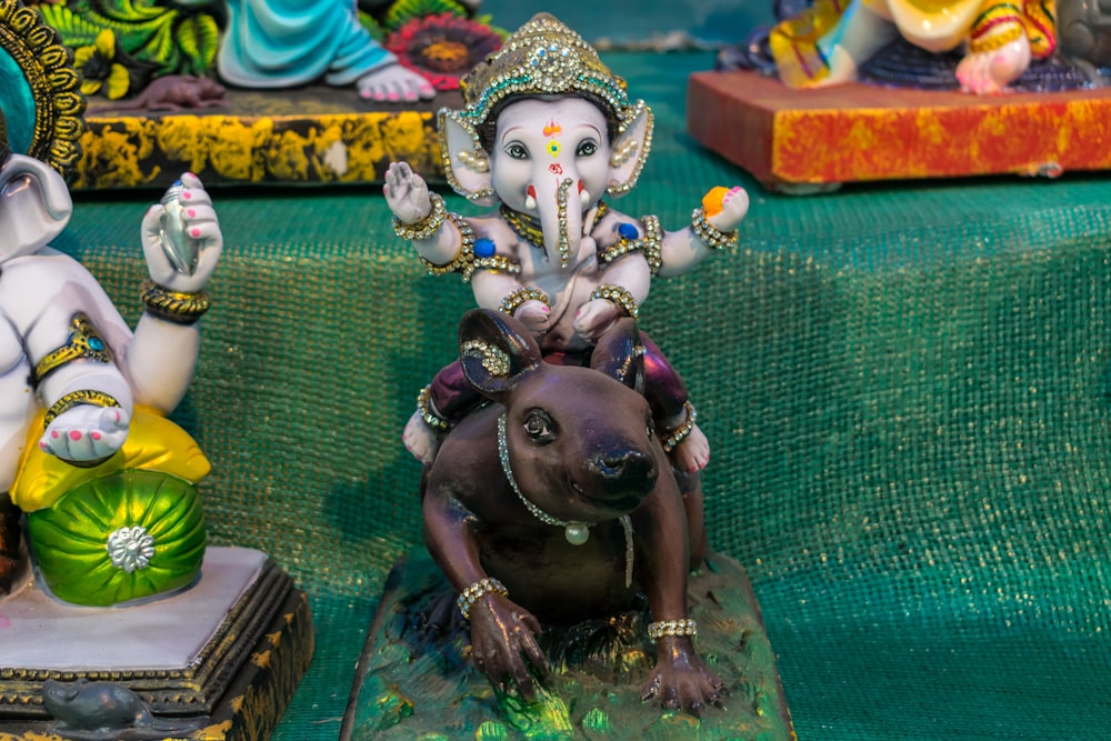 a statue of an elephant and a dog on a table