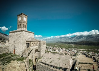 a clock tower on top of a stone building