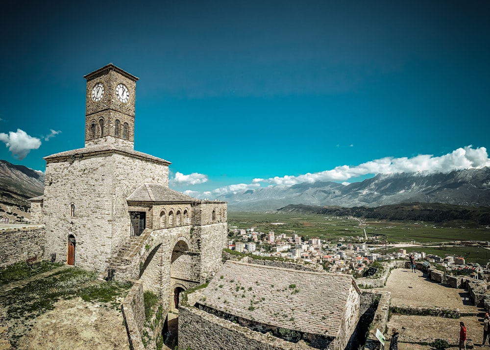 a clock tower on top of a stone building