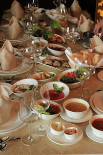 A beautifully arranged table with a variety of gourmet dishes and drinks.