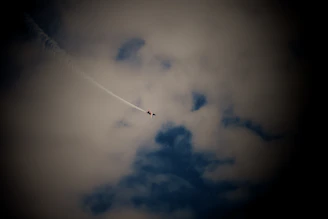 The L39 Albatros performing a sharp banking maneuver with smoke trails behind