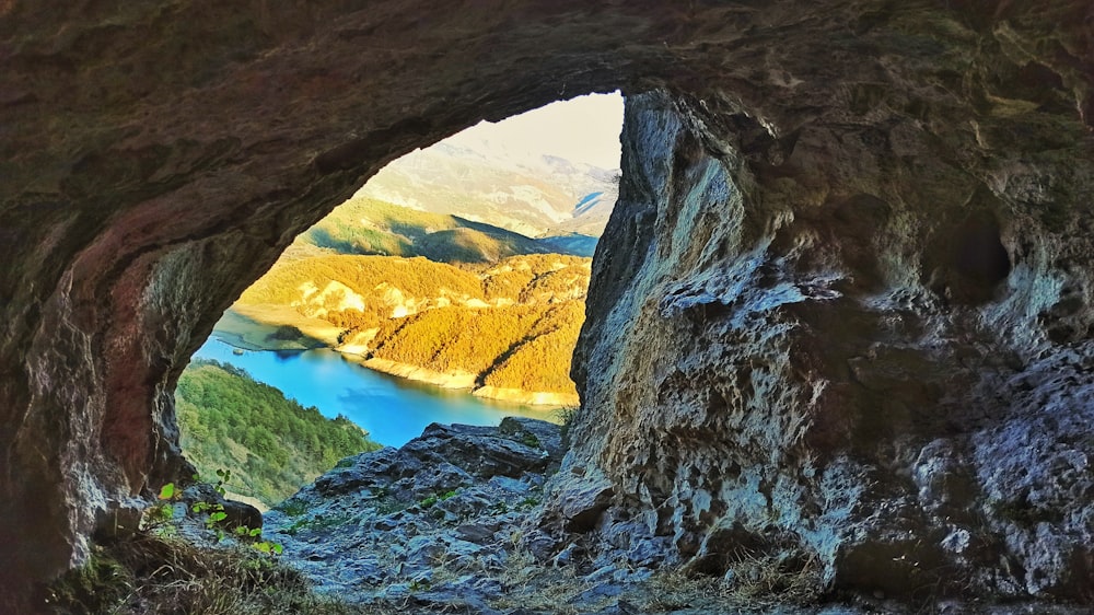 a view of a lake through a cave