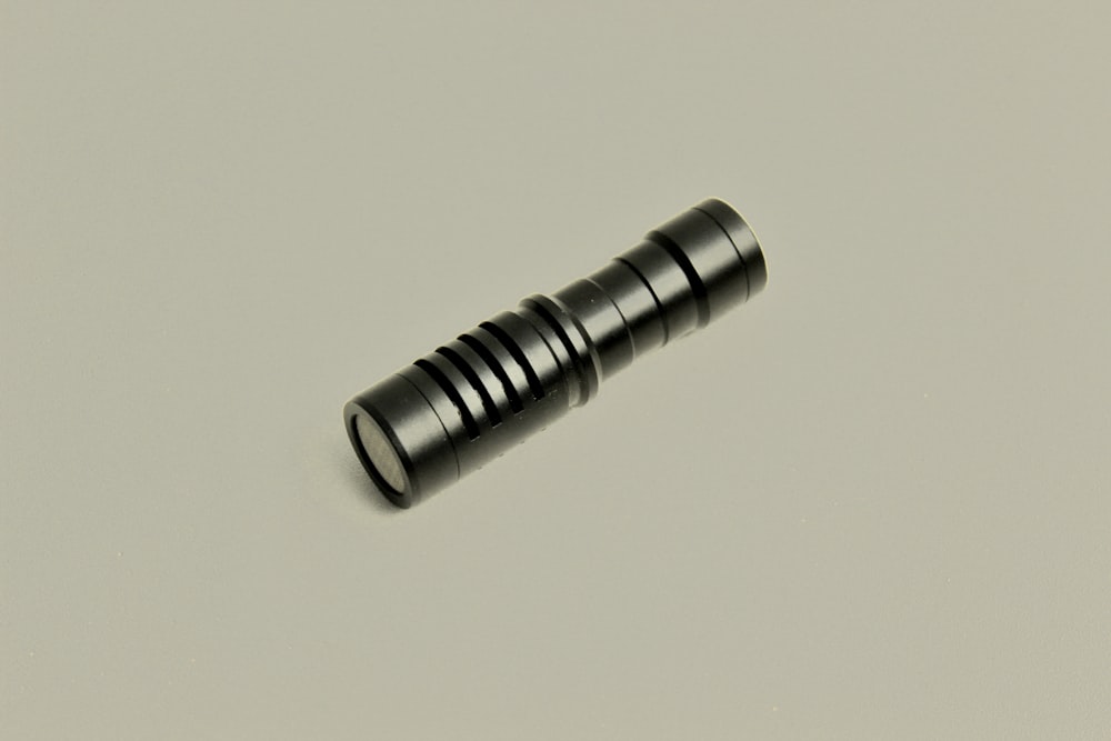 a close up of a black object on a white surface