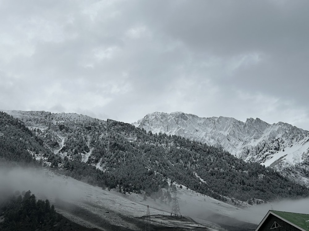 a black and white photo of a snowy mountain